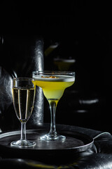 Cocktail with ice on a dark background. Bar