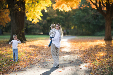 Mothers day, love family.  Family on autumn walk in nature outdoors. Mother and child with hugging tenderness