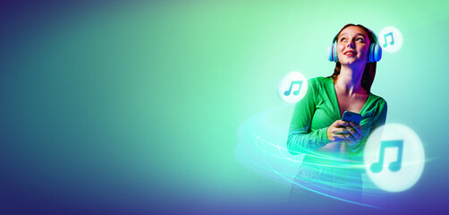 Young lady dancing, smoothly moves during listening music radiating positive energy against abstract background in green neon light with copy space .