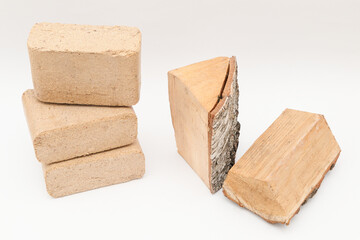 Alternative fuel, eco fuel, bio fuel. Wooden briquettes vs firewood on white background.