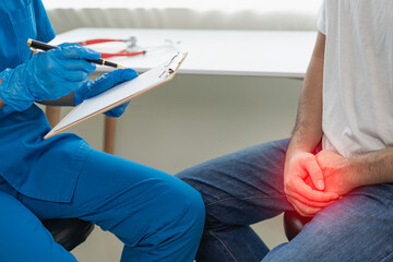 Young man who has lost sexual function Pain in the urinary tract, young man clenches his fist in the prostate area, health concept, prostate pain Close-up pictures