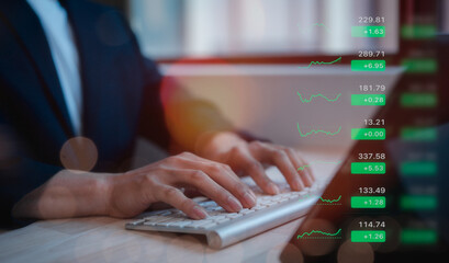 investment and trading in stock market concept businessman  using computer keyboard analysing...