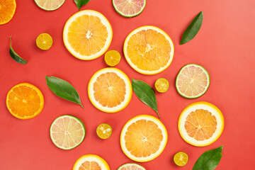 Citrus Fruits and Leaves on Red Background