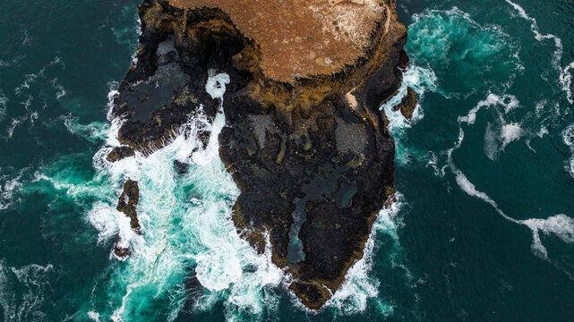 Aerial of the wild coastline with basalt pools on the Atlantic coastline, Dombe Grande, Namibre, Angola