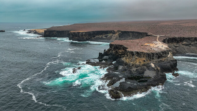 Aerial of the wild coastline with basalt pools on the Atlantic coastline, Dombe Grande, Namibre, Angola