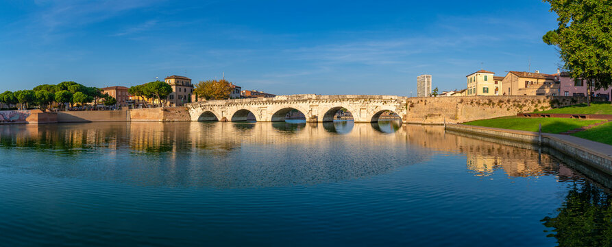 View of Ponte di Tiberio reflecting in Rimini Canal, Rimini, Emilia-Romagna