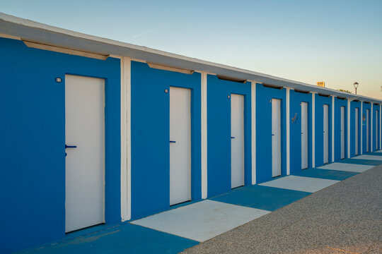 View of blue and white beach huts on the Lido on Rimini Beach, Rimini, Emilia-Romagna
