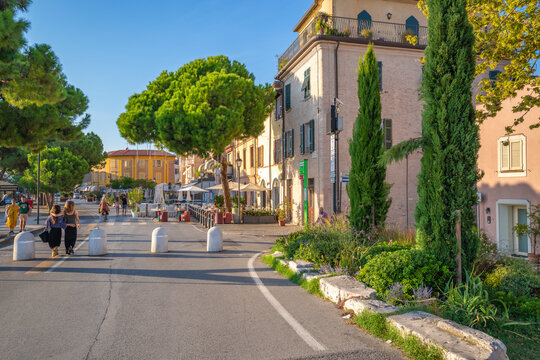 View of colourful buildings, cafe and cypress trees in Borgo San Giuliano, Rimini, Emilia-Romagna