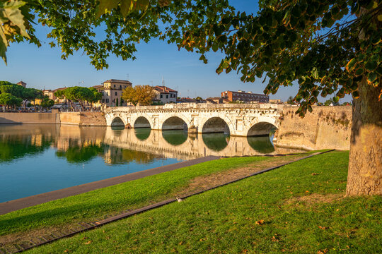 View of Ponte di Tiberio reflecting in Rimini Canal, Rimini, Emilia-Romagna