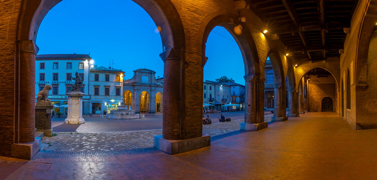 View of Piazza Cavour from arches of Palazzo del Podesta in Rimini at dusk, Rimini, Emilia-Romagna