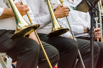 ands and trumpets of symphony orchestra musicians close up - obrazy, fototapety, plakaty