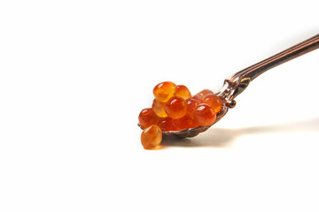 Red salmon caviar. Red fish roe on a spoon. Raw seafood. Elite delicacies. Protein healthy food. White background.  