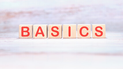 BASICS word made of wooden cubes on a light background