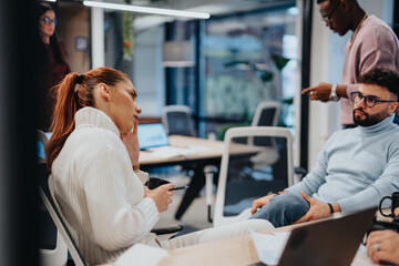 A diverse group of professionals collaborating and strategizing in a modern corporate office.