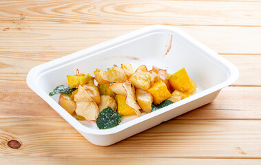 Fruit salad with mint. Healthy diet. Takeaway food.  On a wooden background.