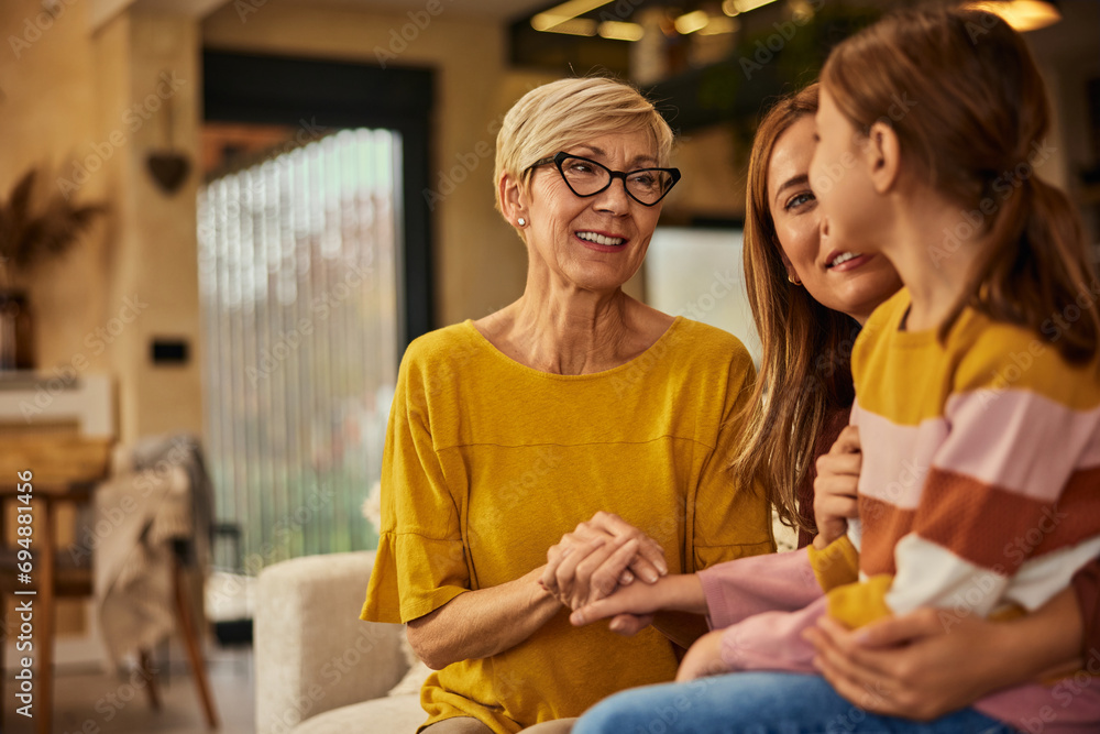 Canvas Prints Focus on the smiling grandma, looking at her grandchild while she sitting in her mothers lap.