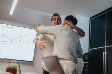 Colleagues bid farewell in an office setting, with a departing employee shaking hands and greeted by coworkers. Employee leaving for new opportunities.
