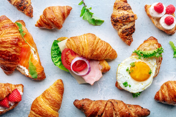 Croissant sandwich assortment. Many stuffed croissants, overhead flat lay shot. Rolls filled with...