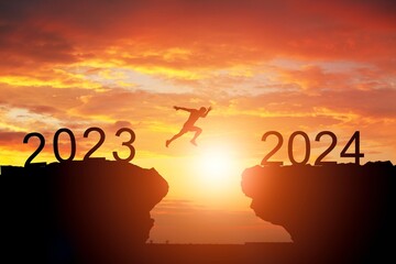 Welcome new year 2024, Silhouette jumping on cliff