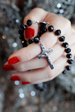 Catholic woman praying rosary beads and crucifix, Vietnam, Indochina