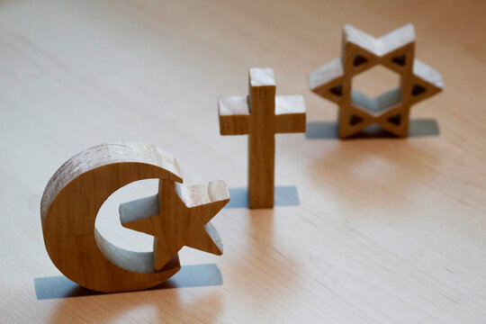 Christianity, Islam, Judaism, the three monotheistic religions in symbols of Jewish Star, Christian Cross and Islamic Crescent, France