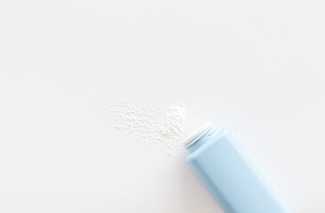 Spilled baby talcum powder. Container with powder for baby body care