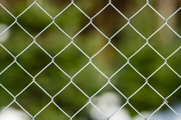 Fototapeta premium Chain link metal wire fence, close up shot, shallow depth of field, no people
