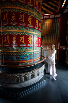 Buddha Tooth Relic Temple, Viarocana Buddhist prayer wheel and worshipper, Singapore