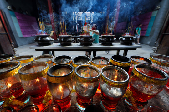 The Thien Hau Temple, the most famous Taoist temple in Cholon, red candles and incense sticks on joss stick pot burnt to pay respect to the Buddha, Ho Chi Minh City, Vietnam