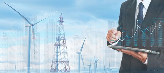 Businessman invests in electric power stocks, on a background with network antennas and wind turbines.