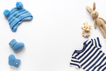 Set of baby boy dress - blue bodysuit with knitted hat and boots, top view. Kids clothing flat lay