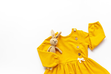 Flat lay of yellow baby dress and accessories. Kids wear clothes flat lay
