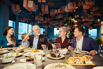 Little boy having fun with aged man celebrating New Years Eve