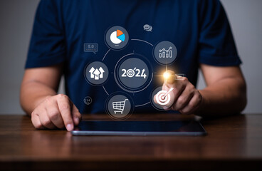 Marketing Trends for newyear 2024 concept, Businessman searching for 2024 trends for marketing monitor and business planing in new year concept.