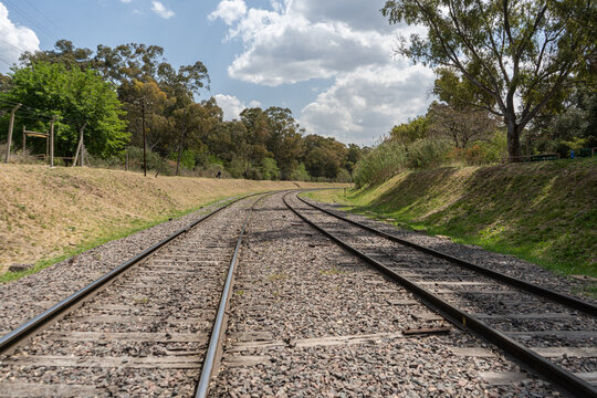 train tracks under a blue sky