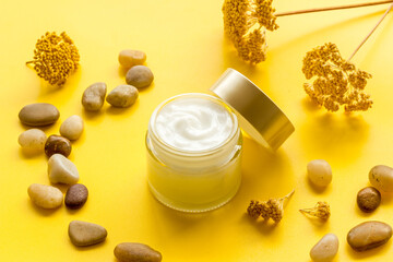 Cosmetic cream for face or body with flowers. Skincare products concept