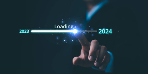 Businessman touch on loading progress from 2023 to 2024,Planning and challenge strategy in new year 2024 Concept. New business startup in 2024. New year 2024 is loading, calendar date, end of the year - obrazy, fototapety, plakaty