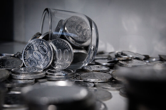 laptop and Indonesian rupiah coins