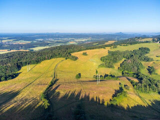 Fototapeta na wymiar Green hilly landscape with green meadows and forests. Jested ridge near Liberec, Czechia. Aerial view from drone.