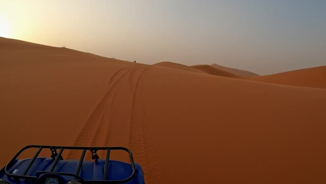 Quad biking in the desert of Merzouga at sunset