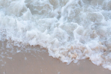 Wave on the sandy beach. Close up