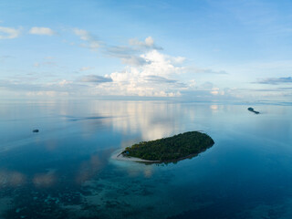 Early morning light illuminates the remote island of Koon near Seram, Indonesia. This scenic...