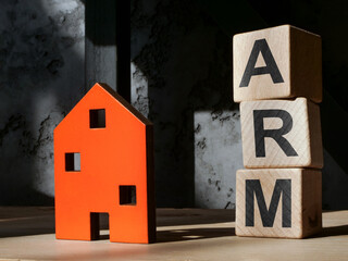 House figurine and cubes ARM adjustable rate mortgage.