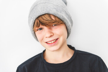 Teen boy in blank black wearing gray toque t-shirt, isolated on white background.