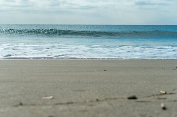 青い空と青い海のうねりと砂浜