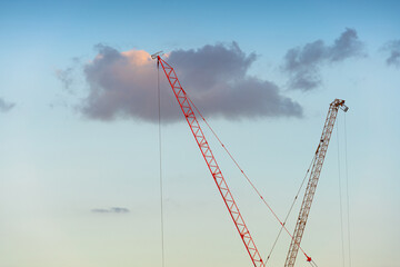 crane construction engineer work with worker for build high skyline condominium and office in downtown, investment in estate and business concept