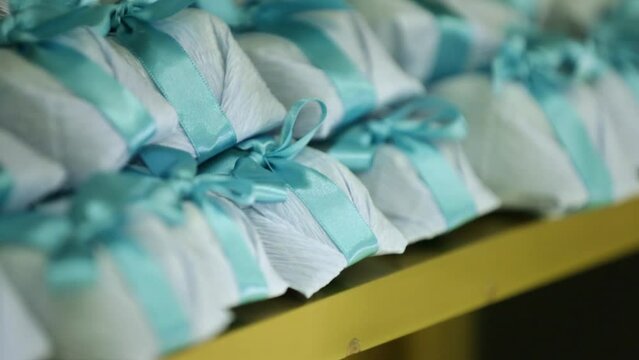 Brazilian sweets called bem-casado for wedding, birthday or baptism party with blue bow