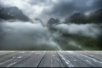 After rain. landscape of foggy valley with empty wooden table