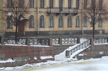 Winter view of the descent to the water on the river embankment in the city, Fontanka River...