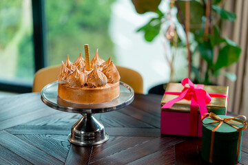 close-up of a delicious appetizing cake with a candle standing on a stand during a birthday party in a restaurant